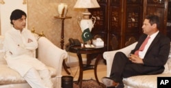 In this photo released by Pakistan's Press Information Department, July 7, 2017, Pakistani Interior Minister Chaudhry Nisar Ali Khan, left, meets Vice President of Facebook Joel Kaplan in Islamabad, Pakistan.