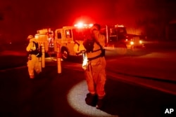 Firefighter Adrien Mahnke pauses while battling the Camp Fire as it tears through Paradise, Calif., on Nov. 8, 2018.