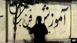 A policeman stands guard near the site of a deadly suicide attack, in Kabul, Afghanistan, Monday, June 11, 2018. (AP Photo/Rahmat Gul)
