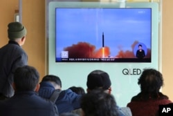 FILE - People watch a TV screen showing file footage of North Korea's missile launch at Seoul Railway Station in Seoul, South Korea, Nov. 21, 2017.