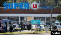 A general view shows gendarmes and police officers at a supermarket after a hostage situation in Trebes, France, March 23, 2018.