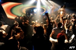 FILE - This general view shows Taiwanese dancing at a club during a "ladies night" promotion in the Chung-Li area of Taoyuan county, north of Taipei in northern Taiwan on April 3, 2010. (Photo by SAM YEH / AFP)