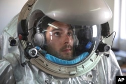 This Feb. 7, 2018, photo shows Joao Lousada, a flight controller for the International Space Station, wearing an experimental space suit during a simulation of a future Mars mission in the Dhofar desert of southern Oman.