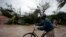 A man pushes a bicycle in a flood zone after Hurricane Matthew passed through Les Cayes, Haiti, Oct. 4, 2016. 