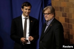 FILE - Jared Kushner, husband of Ivanka Trump, and Stephen Bannon stand by as Republican presidential nominee Donald Trump holds a campaign rally in Canton, Ohio, Sept. 14, 2016.