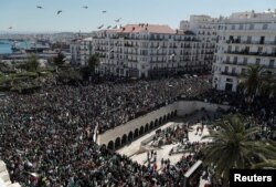 People gather during a protest over President Abdelaziz Bouteflika's decision to postpone elections and extend his fourth term in office, in Algiers, Algeria March 15, 2019.