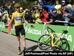 Britain's Chris Froome reacts after he crashed at the end of the twelfth stage of the Tour de France cycling race