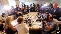Summer Zervos, foreground left, alongside her attorney, addresses the media during a news conference in Los Angeles, Oct. 14, 2016. Zervos, a former contestant on "The Apprentice" says Republican presidential candidate Donald Trump made unwanted sexual advances toward her in 2007.