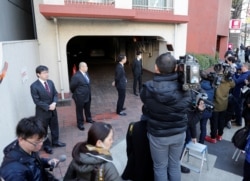 Journalists are seen in front of the residence of former Nissan Motor Chairman Carlos Ghosn in Tokyo, Japan, April 4, 2019.