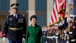 South Korean President Park Geun-hye reviews the troops during a full military honors parade to welcome her, Thursday, Oct. 15, 2015, at the Pentagon.
