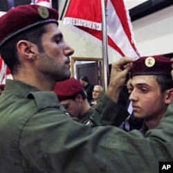 A Hezbollah fighter fixes the beret of a fellow member during a speech by Hezbollah leader Hassan Nasrallah in the southern suburb of Beirut (File)