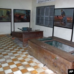 Paintings by human rights icon and artists Vann Nath depicting how torture devices were used hang on the walls of Tuol Sleng Prison in Phnom Penh, Cambodia, June 2011.