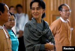 National League for Democracy (NLD) party leader Aung San Suu Kyi smiles as she arrives to attend Union Parliament in Naypyitaw, Myanmar, Jan. 28, 2016.