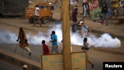 Tear gas disperses Sudanese demonstrators during anti-government protests in the outskirts of Khartoum, Sudan, Jan. 15, 2019.