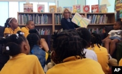 Education Secretary Betsy DeVos reads to students at Eagle Academy Public Charter School in Washington, Friday, June 2, 2017.