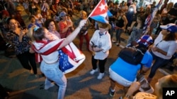 Members of the Cuban community dance in the street as they react to the death of Fidel Castro in front of the Versailles Restaurant in the Little Havana neighborhood of Miami, Nov. 26, 2016.