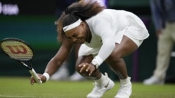 Serena Williams of the US falls to the ground during the women's singles first round match against Aliaksandra Sasnovich of Belarus on day two of the Wimbledon Tennis Championships in London, Tuesday June 29, 2021. (AP Photo/Kirsty Wigglesworth)