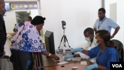 CDC epidemiologist Kerton Victory observes medical students conducting exit screening at Guinea's Conakry International Airport on Sept. 24, 2014.