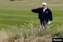 U.S. President Donald Trump gestures as he walks on the course of his golf resort, in Turnberry, Scotland, July 14, 2018.