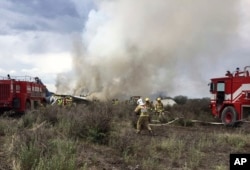 Rescue workers and firefighters are seen at the site where an Aeromexico airliner has suffered an "accident" in a field near the airport of Durango, Mexico, July 31, 2018.