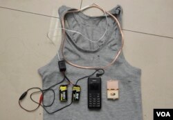 A hidden coil in a shirt, two batteries, a mobile phone and a receiver were found on a student and confiscated by the authorities as cheating equipment for a Chinese test in Chengdu, Sichuan province in 2014. (REUTERS)