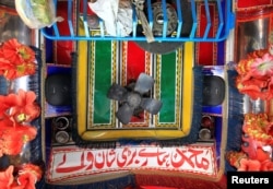 Speakers and a fan are seen in the cab of a decorated truck in Faisalabad, Pakistan, May 4, 2017.