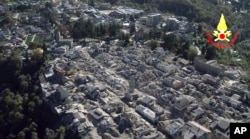 FILE - An aerial view of the destroyed hilltop town of Amatrice after an earthquake with a preliminary magnitude of 6.6 struck central Italy, Oct. 30, 2016.