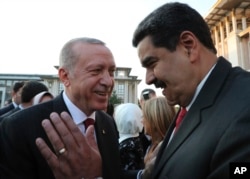 FILE - Turkey's President Recep Tayyip Erdogan (L) talks to Venezuela's President Nicolas Maduro (R) prior to a dinner following a ceremony at the Presidential Palace in Ankara, Turkey, July 9, 2018.