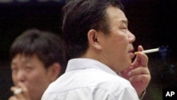 Local men smoke cigarettes in Shanghai, China.