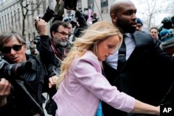 FILE -Stormy Daniels arrives at federal court in New York to attend a court hearing where a federal judge is considering how to review materials that the FBI seized from President Donald Trump's personal lawyer.