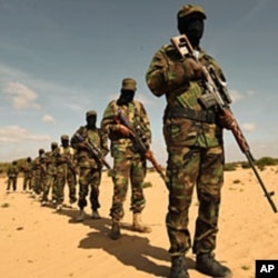 Members of Somalia's al-Shabaab militant group parade during a demonstration to announce integration with al Qaida, in Elasha, south of the capital Mogadishu, February 13, 2012
