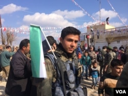 Syrian soldiers and families rally in Soran, Syria on Feb. 1, 2018. (H.Murdock/VOA)