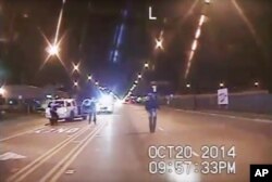 FILE - A frame grab from dash-cam video provided by the Chicago Police Department shows Laquan McDonald (R) walks down the street moments before being shot by officer Jason Van Dyke on Oct. 20, 2015.