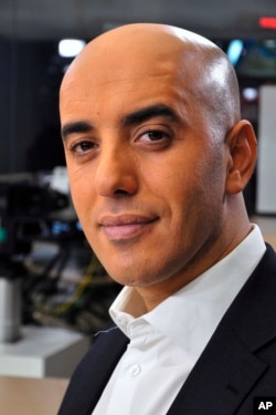 FILE - Notorious French gangster Redoine Faid poses for a photo prior to an interview with French TV channel, LCI, in Boulogne-Billancourt, outside Paris, France, Nov. 22, 2010.