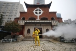 A worker disinfects the Hankou Salvation Church in Wuhan, in China's central Hubei province on March 6, 2020.