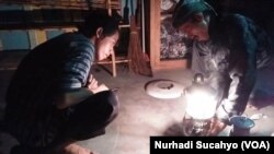 Staf Kampung Mataraman menghidupkan petromaks, lampu minyak yang dulu biasa dipakai masyarakat