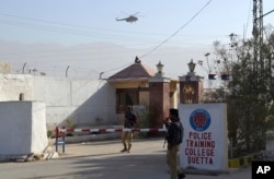 Pakistani police officers stand guard outside a police training center which was attacked by militants in Quetta, Pakistan, Oct. 25, 2016.