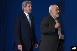 US Secretary of State John Kerry, left, and Iranian Foreign Minister Javad Zarif arrive to deliver a statement, at the Swiss Federal Institute of Technology, or Ecole Polytechnique Federale De Lausanne, in Lausanne, Switzerland, Thursday, April 2, 2015.