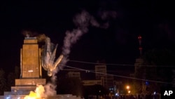 Activists topple Ukraine's biggest monument to Lenin at a pro-Ukrainе rally in the central square of the eastern city of Kharkiv Sept. 28, 2014.