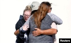 Mourners react outside a reception center for families of victims of a mass shooting in Thousand Oaks, Calif., Nov. 8, 2018.