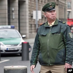 Police patrol sealed-off entrance to the street where the British embassy is situated in Berlin on 05 Oct 2010