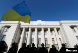 FILE - Police officers stand guard during an anti-corruption rally in front of the Ukrainian parliament building in Kyiv, Oct. 18, 2016.