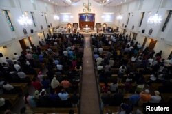 FILE - Worshippers attend their Friday evening Mass at Sacred Heart Catholic Church, as Catholics are awaiting a historic visit by Pope Francis to the United Arab Emirates, in Manama, Bahrain, Jan. 18, 2019.