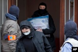 Belgium police leave after an investigation in a house in the Anderlecht neighborhood in Brussels, Belgium, March 23, 2016, one day after Tuesday's deadly suicide attacks on the Brussels airport and its subway system.