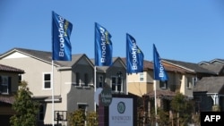A sign advertising new homes is posted at a housing development in Dublin, California.
