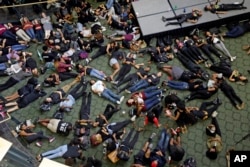 Students at the University of North Carolina-Charlotte hold a vigil by lying on the floor of the student union following Tuesday's police fatal shooting of Keith Lamont Scott at The Village at College Downs apartment complex in Charlotte, N.C., Sept. 21,