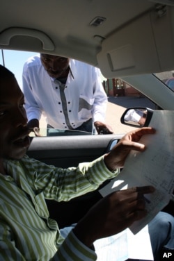 Lekgotla Nkopane (right) shows Treatment Action Campaign member Thabo Nkwe clinic records proving that a state hospital failed to give him his ARV treatment