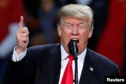 U.S. President Donald Trump uses his famous "You're fired" line at a rally in Pensacola, Fla., Dec. 8, 2017.