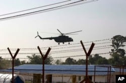 A helicopter carrying an advisory commission lands near newly-built repatriation camps prepared for Rohingya refugees expected to be returning from Bangladesh, Jan. 24, 2018, in Taungpyo, Myanmar.