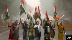 India's main opposition Congress party supporters shout slogans as they arrive to join a protest on the first anniversary of the demonetization announcement, in New Delhi, India, Wednesday, Nov. 8, 2017.